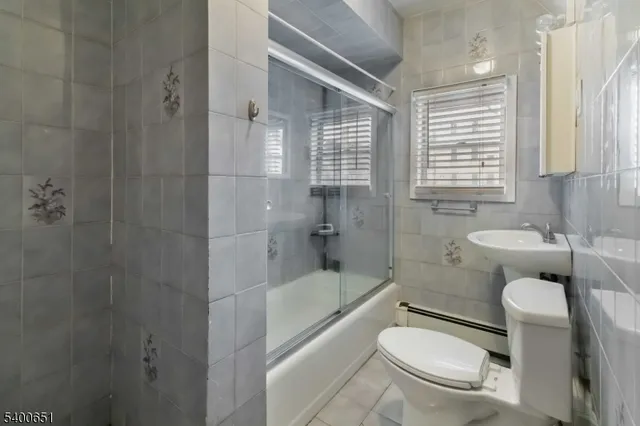 a bathroom with a granite countertop toilet a sink and a bathtub