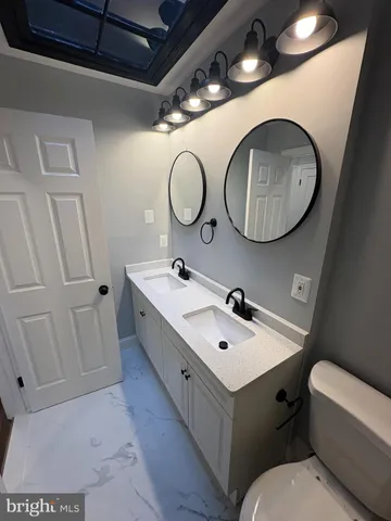a bathroom with a toilet sink and mirror
