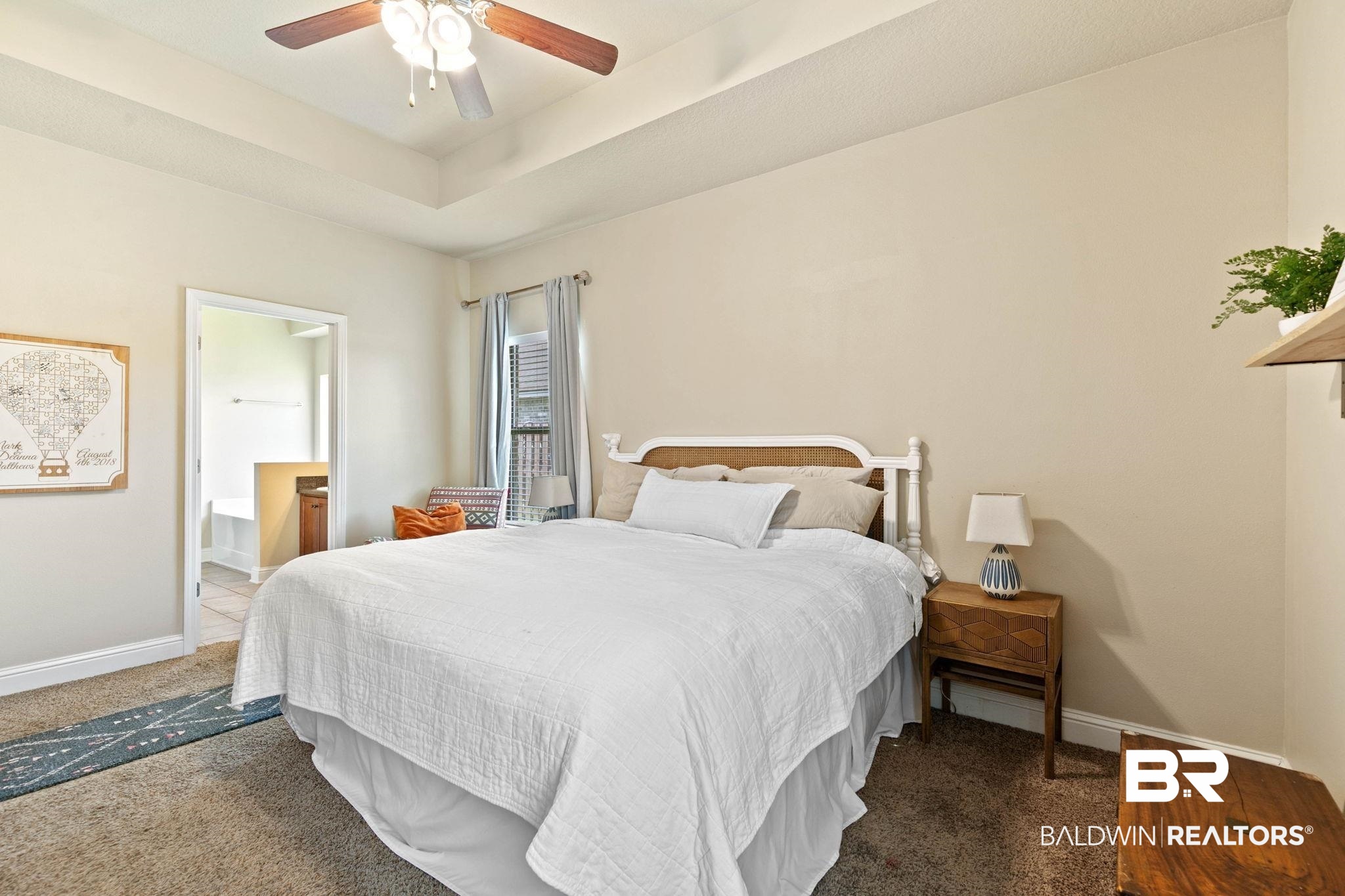 2216 Livingstone Court Mobile, AL 36695 - Photo 21 of 62 Spacious bedroom featuring a tray ceiling with a ceiling fan, neutral wall paint, and carpet flooring