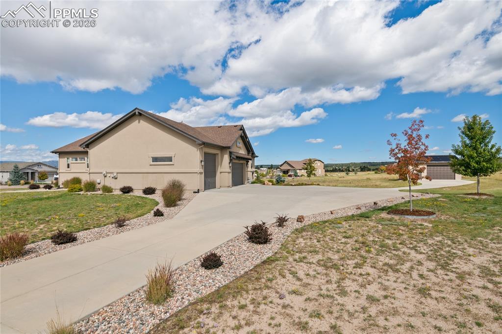 3718 Sky Rim Court Colorado Springs, CO 80908 - Photo 2 of 49 Long driveway leads to the detached garage. Plenty of space to park an RV.