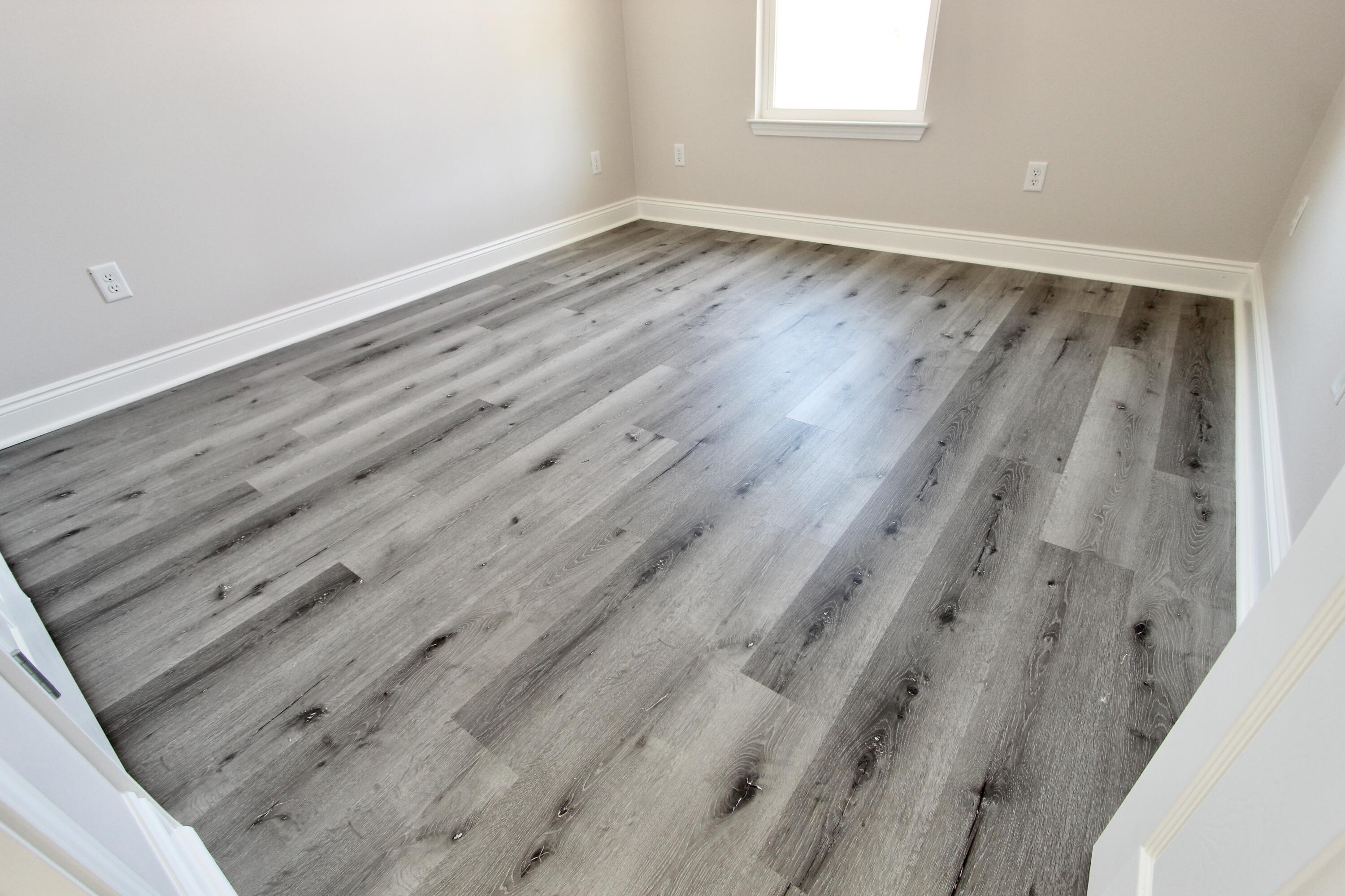 4662 Falcon Way Crestview, FL 32539 - Photo 12 of 20 a view of an empty room with wooden floor and a window