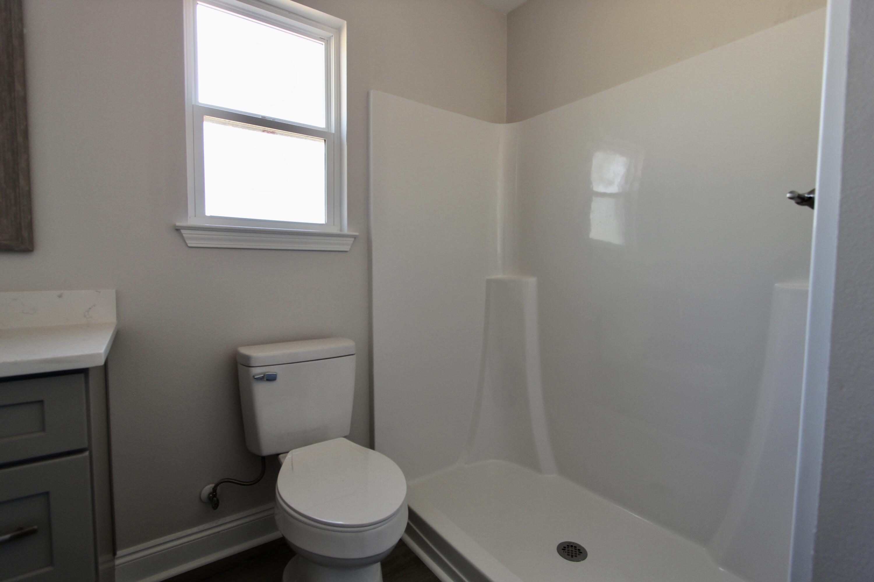 4662 Falcon Way Crestview, FL 32539 - Photo 14 of 20 a white toilet sitting next to a bathroom sink