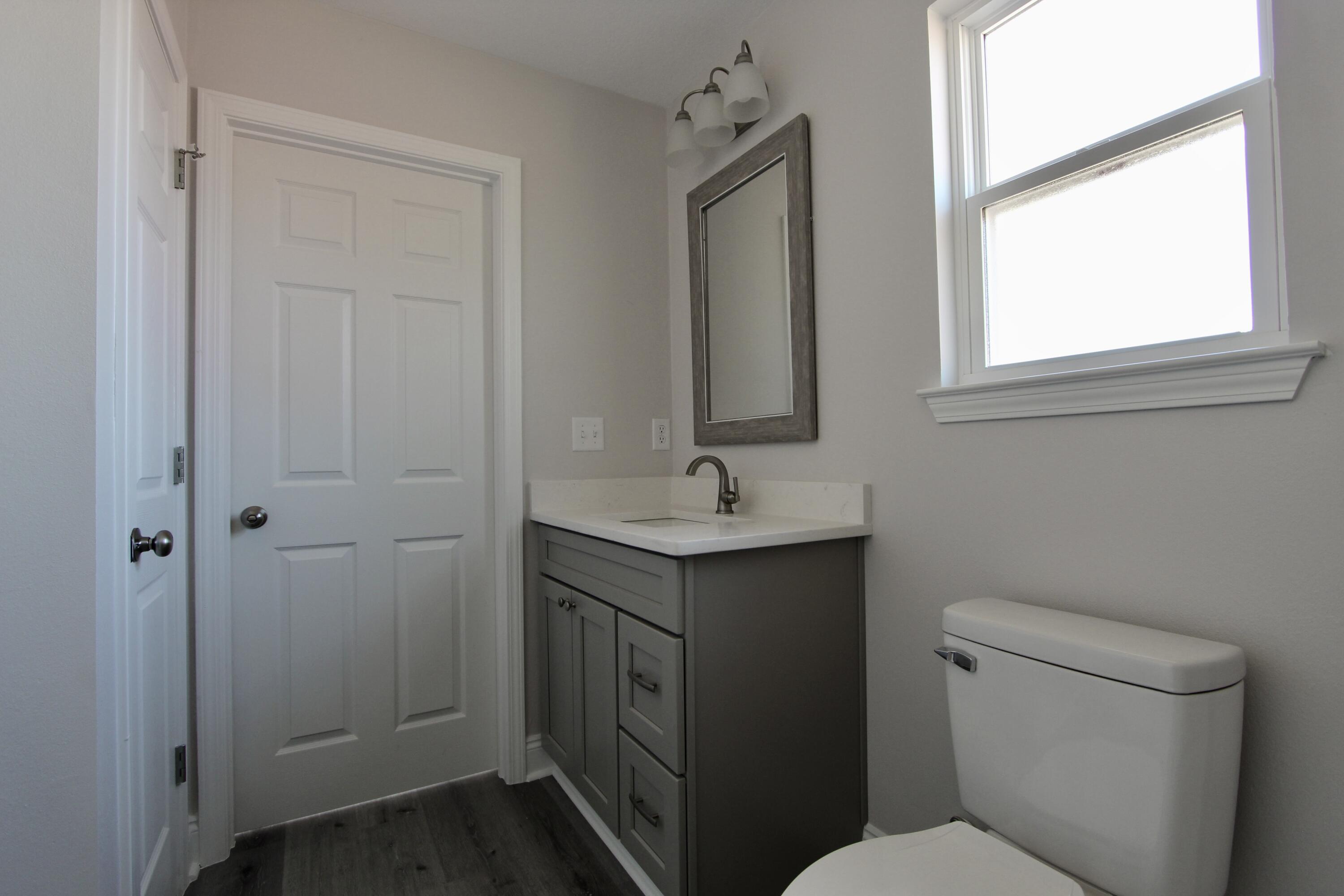 4662 Falcon Way Crestview, FL 32539 - Photo 15 of 20 a bathroom with a toilet sink and mirror
