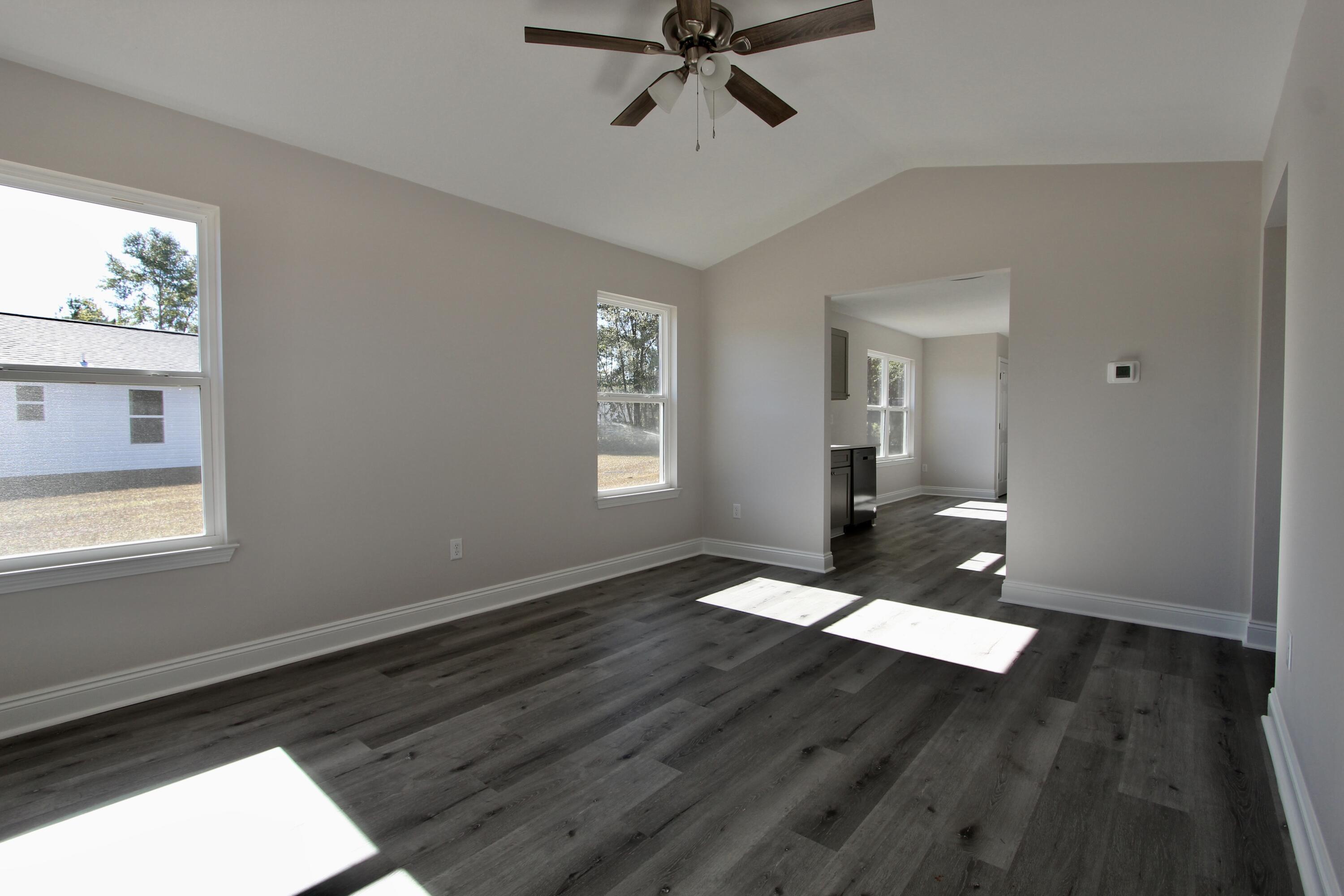 4662 Falcon Way Crestview, FL 32539 - Photo 3 of 20 wooden floor in an empty room with a window