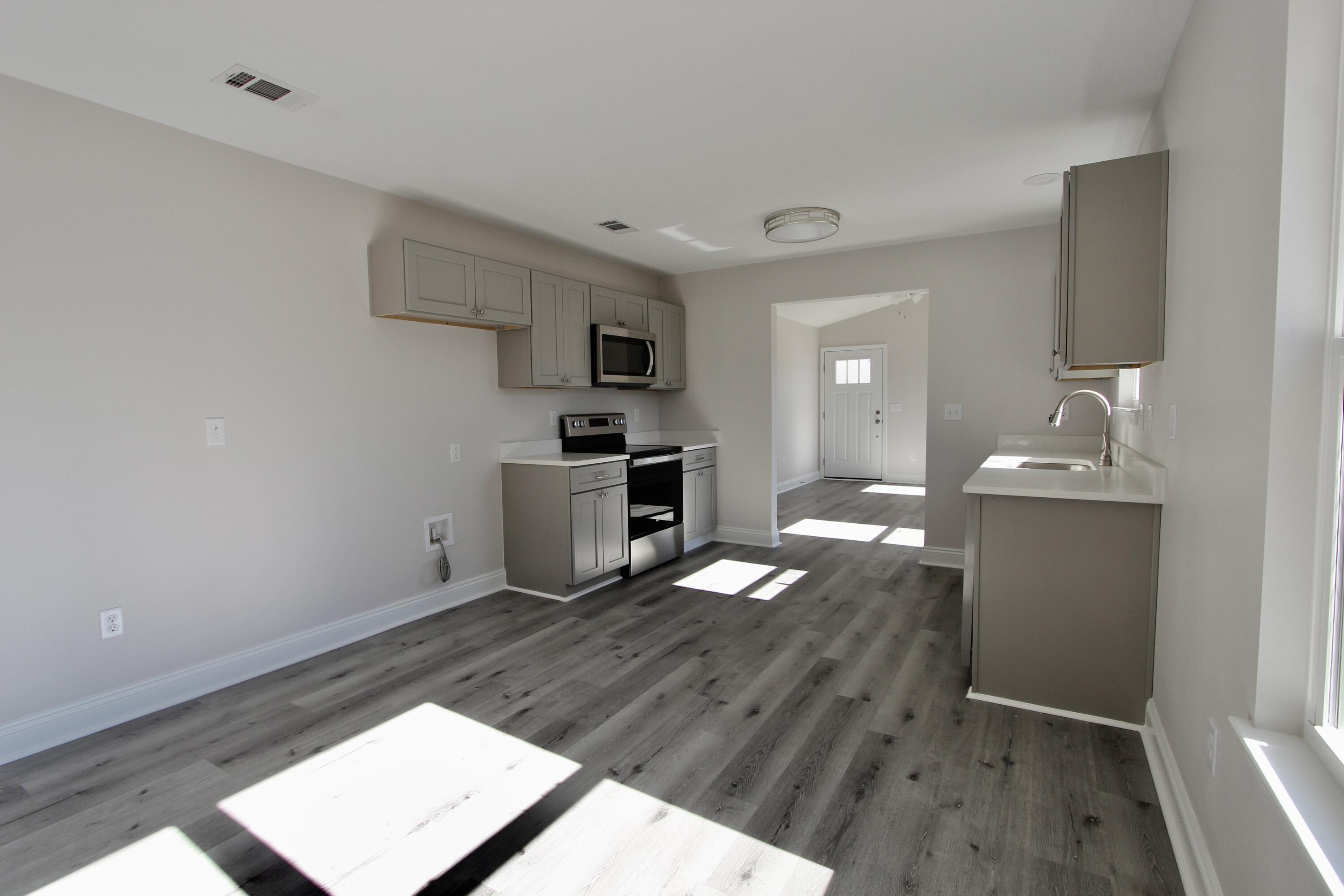 4662 Falcon Way Crestview, FL 32539 - Photo 10 of 20 a kitchen with granite countertop a sink cabinets and wooden floor