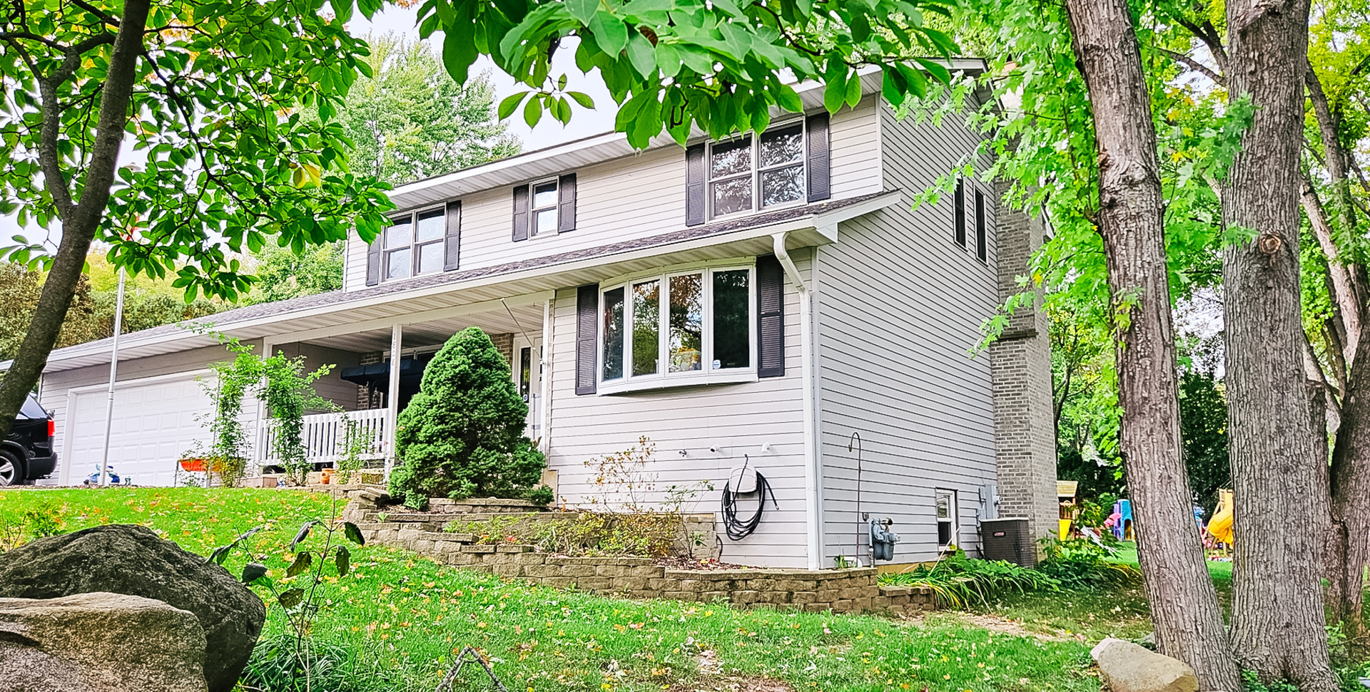 1808 May Drive Johnsburg, IL 60051 - Photo 2 of 32 a front view of a house with garden