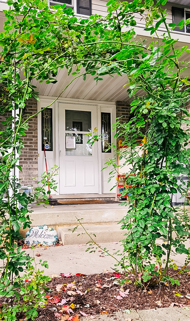 1808 May Drive Johnsburg, IL 60051 - Photo 3 of 32 a front view of a house with garden