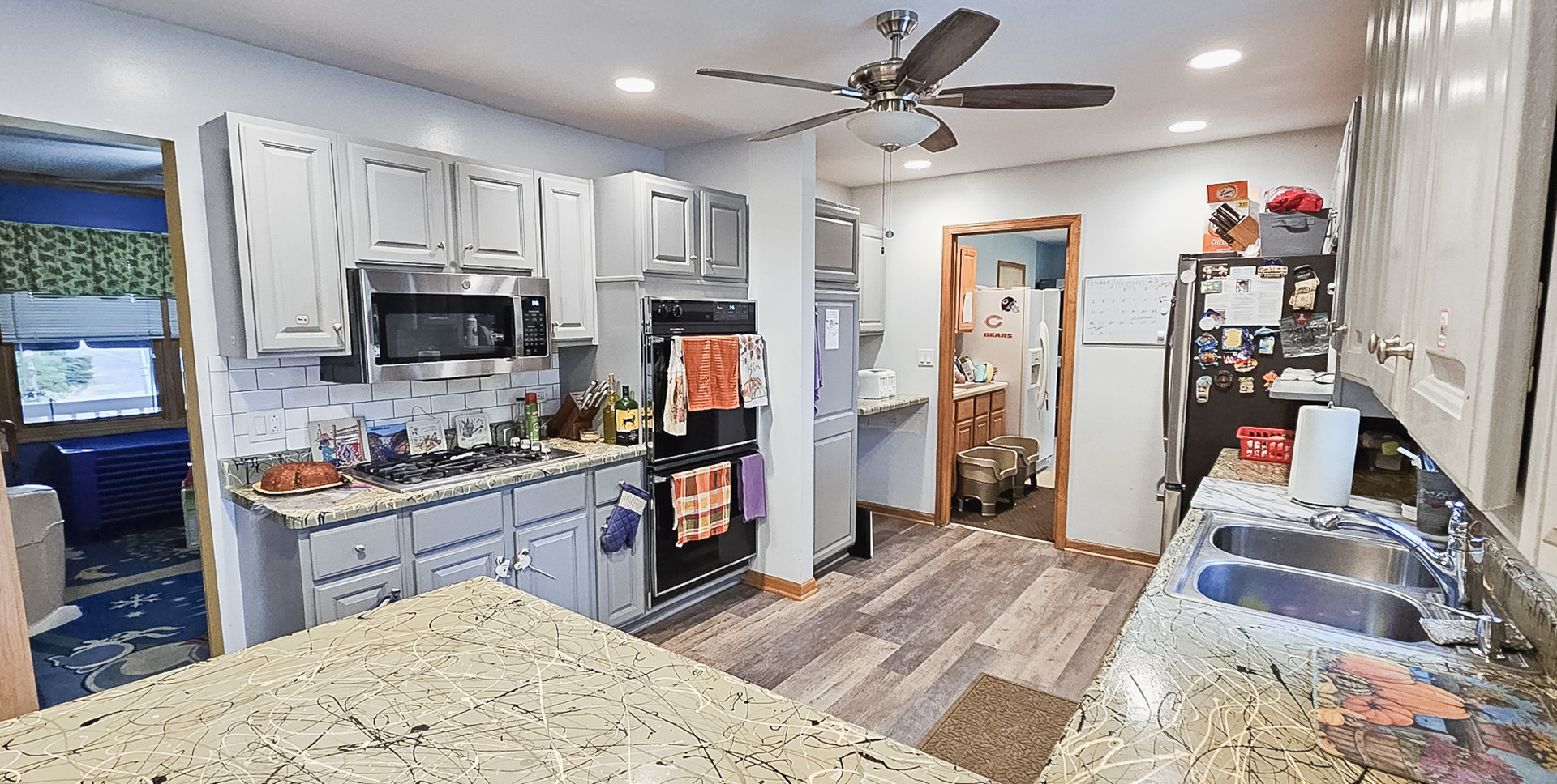 1808 May Drive Johnsburg, IL 60051 - Photo 8 of 32 a kitchen with granite countertop a refrigerator stove top oven and sink