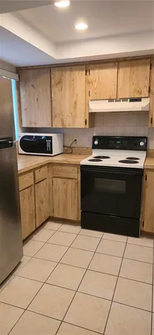 a stove top oven sitting inside of a kitchen