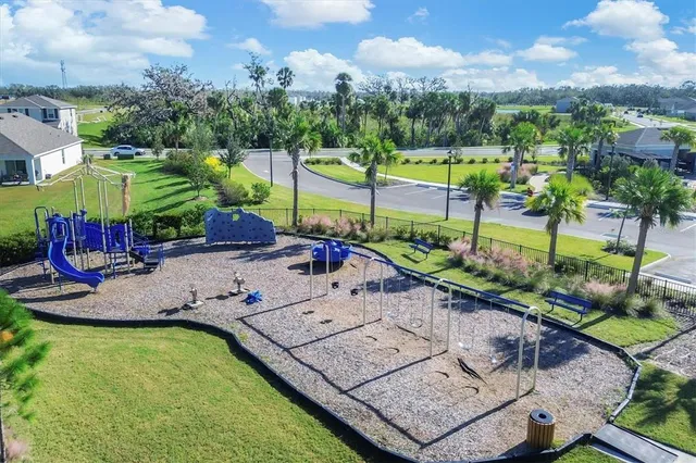 an aerial view of a house with a garden and lake view