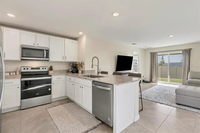 a kitchen with a sink and appliances