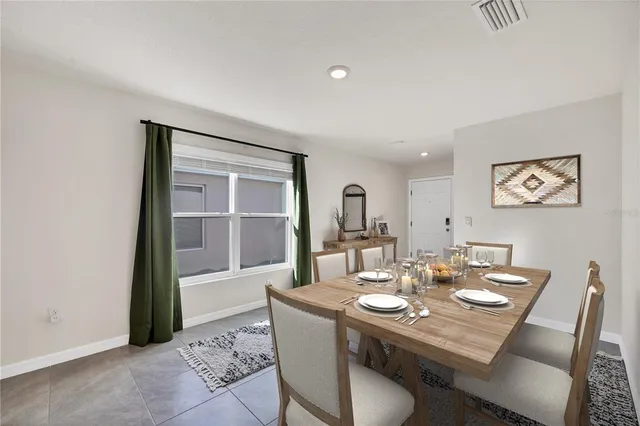 a view of a dining room with a table and chairs