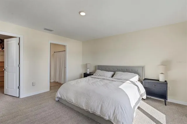 a bedroom with a bed and a night lamp