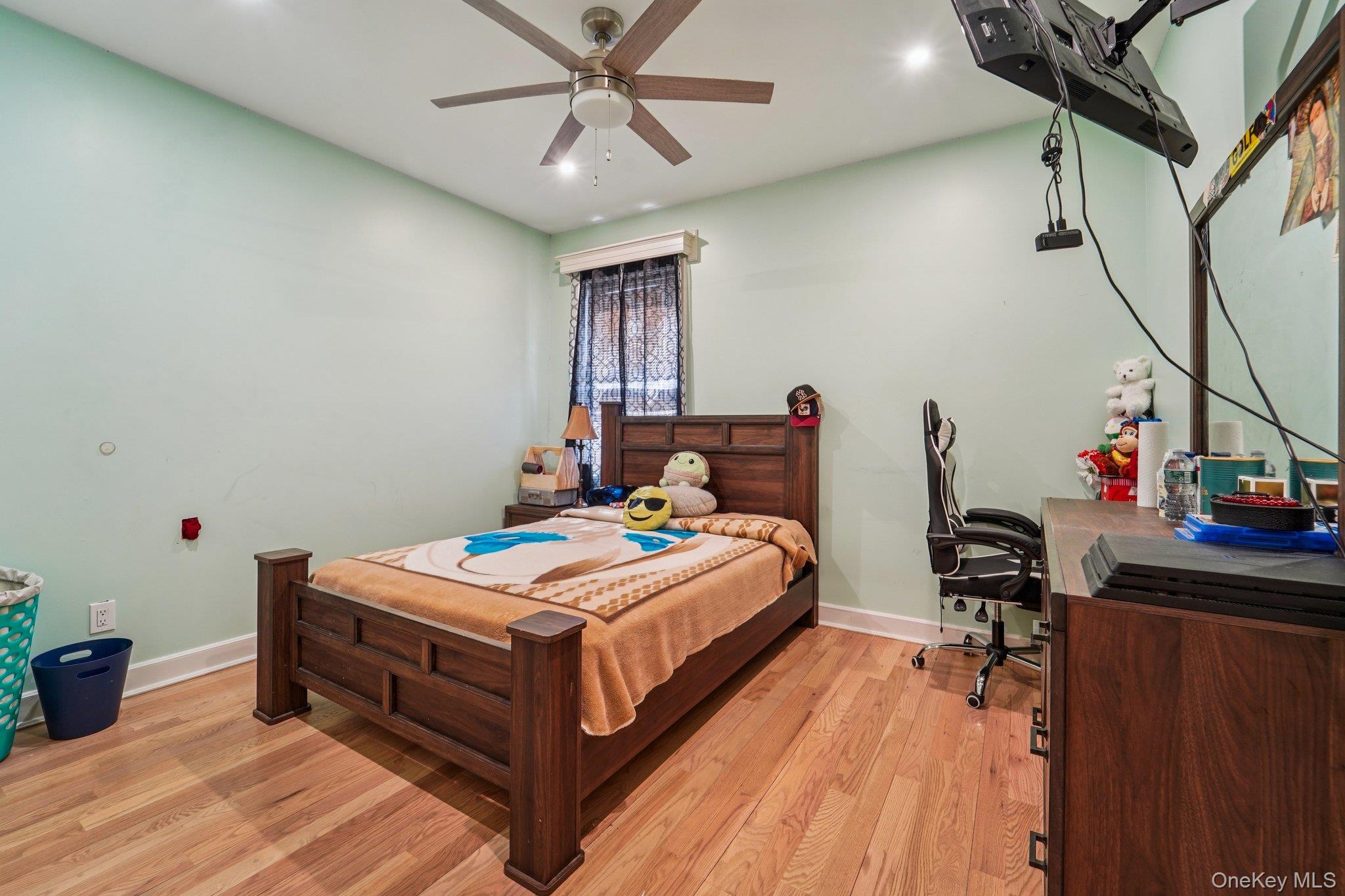 109 Bennett Road Newburgh, NY 12550 - Photo 20 of 41 Bedroom 2: This room features hardwood floors and a ceiling fan with integrated lighting, providing both comfort and illumination.