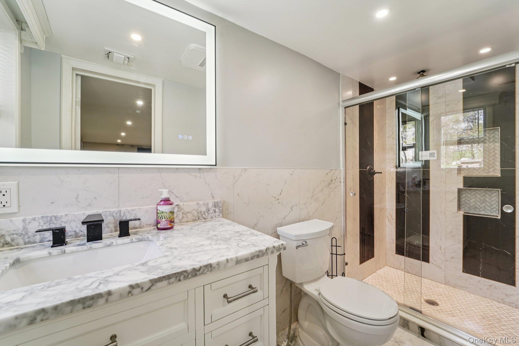 109 Bennett Road Newburgh, NY 12550 - Photo 33 of 41 Bathroom 4: with a vanity featuring a marble countertop and a rectangular sink with black fixtures