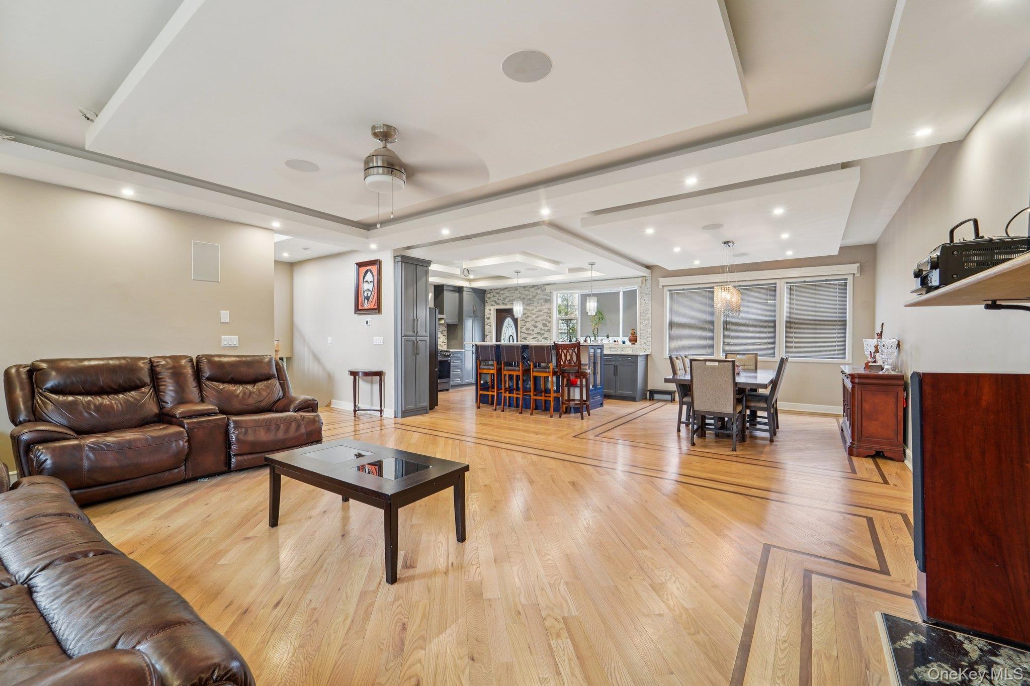 109 Bennett Road Newburgh, NY 12550 - Photo 10 of 41 The property features hardwood floors with an inlaid pattern, tray ceilings with recessed lighting, and a ceiling fan.