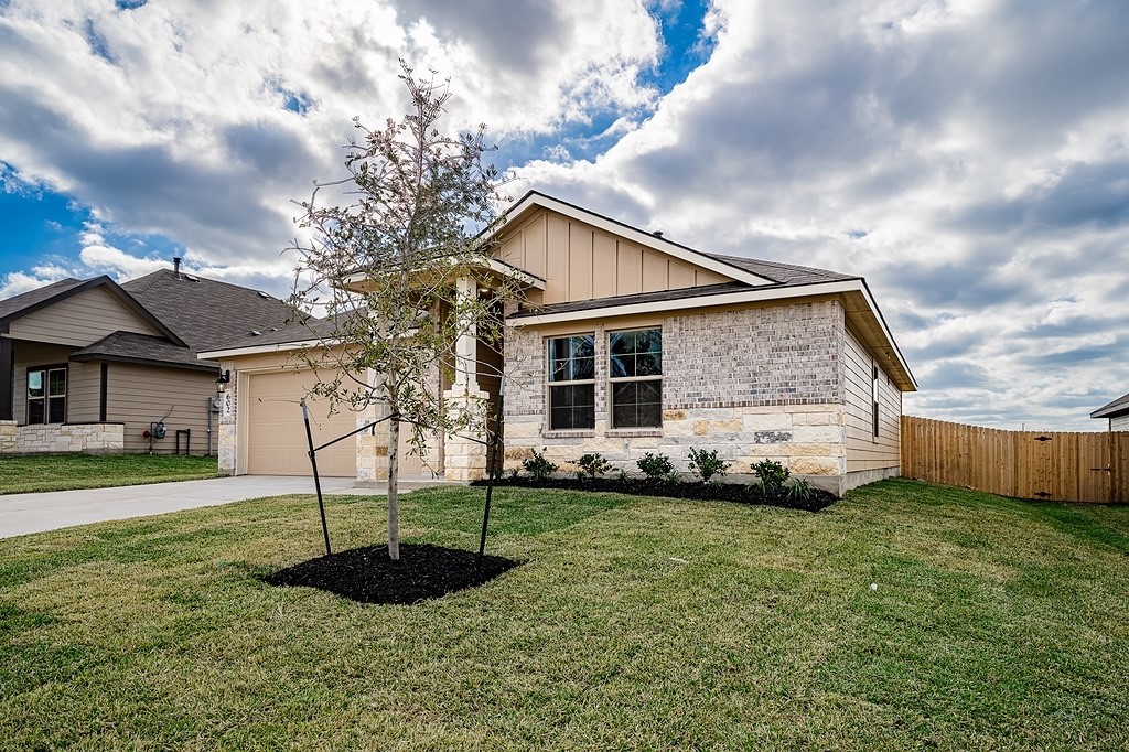 602 Davy Street Brenham, TX 77833 - Photo 1 of 16 a front view of a house with a garden
