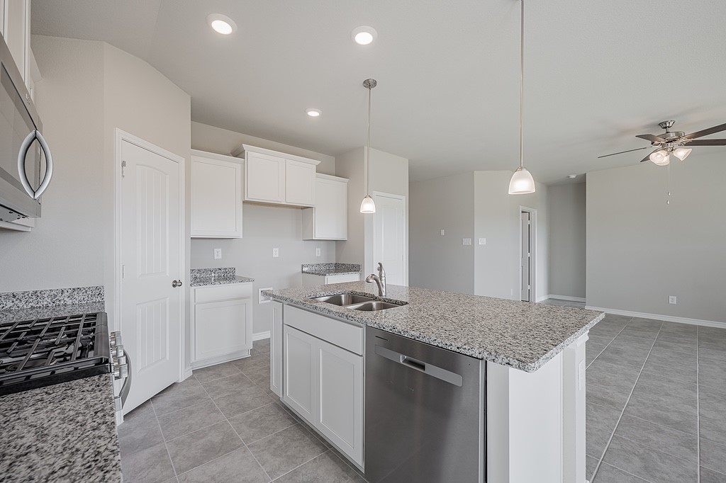 602 Davy Street Brenham, TX 77833 - Photo 6 of 16 a kitchen with stainless steel appliances granite countertop a sink stove and cabinets