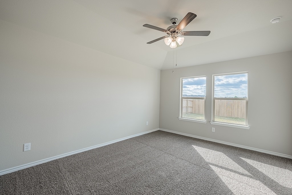 602 Davy Street Brenham, TX 77833 - Photo 8 of 16 an empty room with chandelier fan and windows