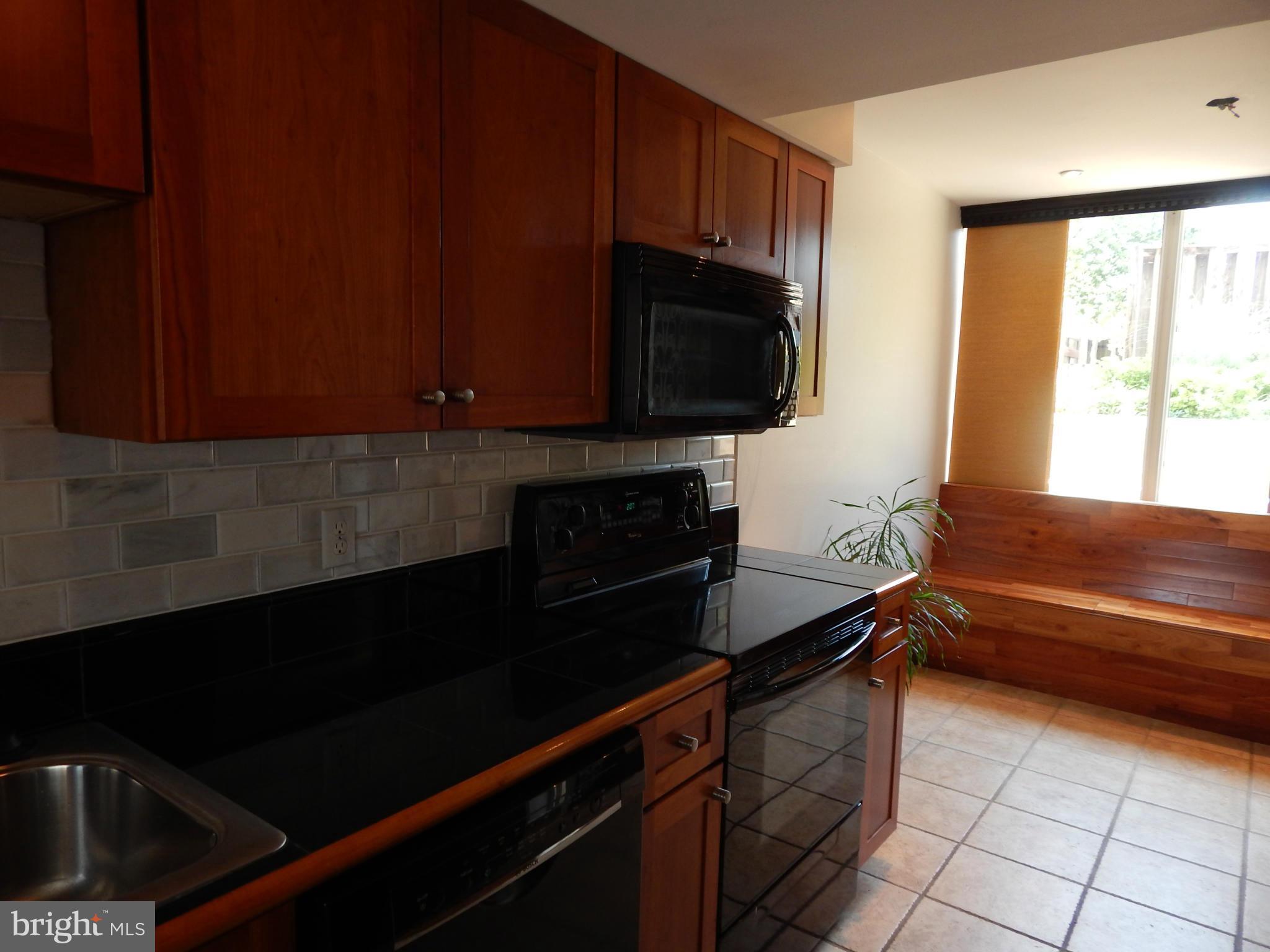 1620 Chimney House Road, Unit 1620 Reston, VA 20190 - Photo 13 of 16 a kitchen with a cabinets and a stove top oven