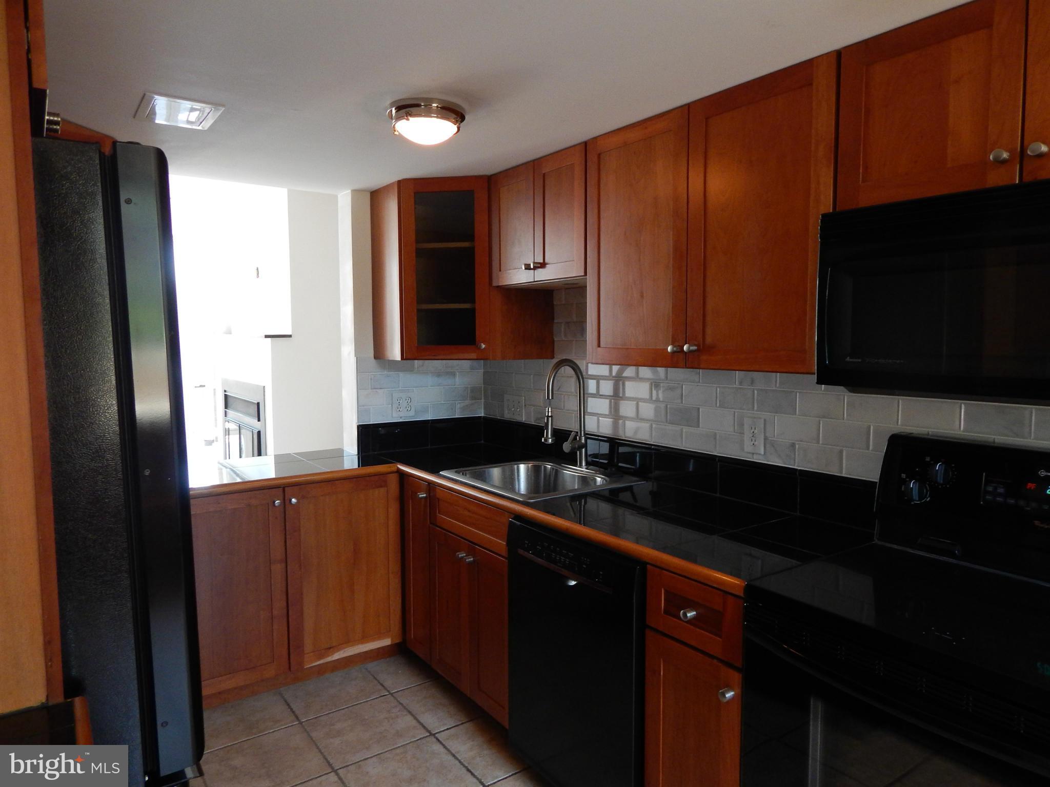 1620 Chimney House Road, Unit 1620 Reston, VA 20190 - Photo 15 of 16 a kitchen with stainless steel appliances granite countertop a refrigerator and a sink