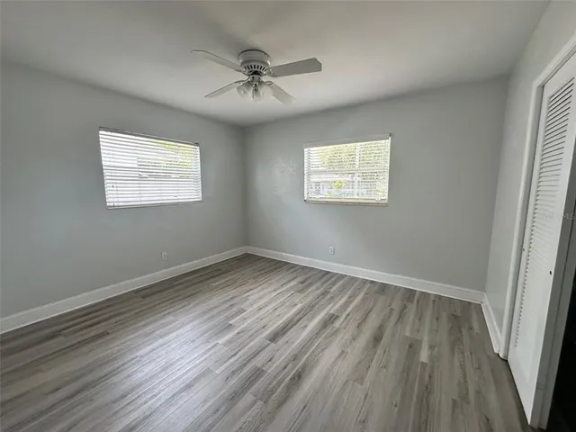 wooden floor in an empty room with a window
