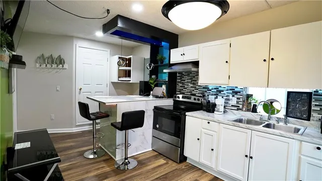 a view of a lounge chair and tables in the patio