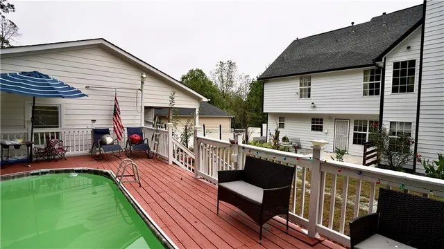 a spacious bathroom with a granite countertop sink a mirror and shower