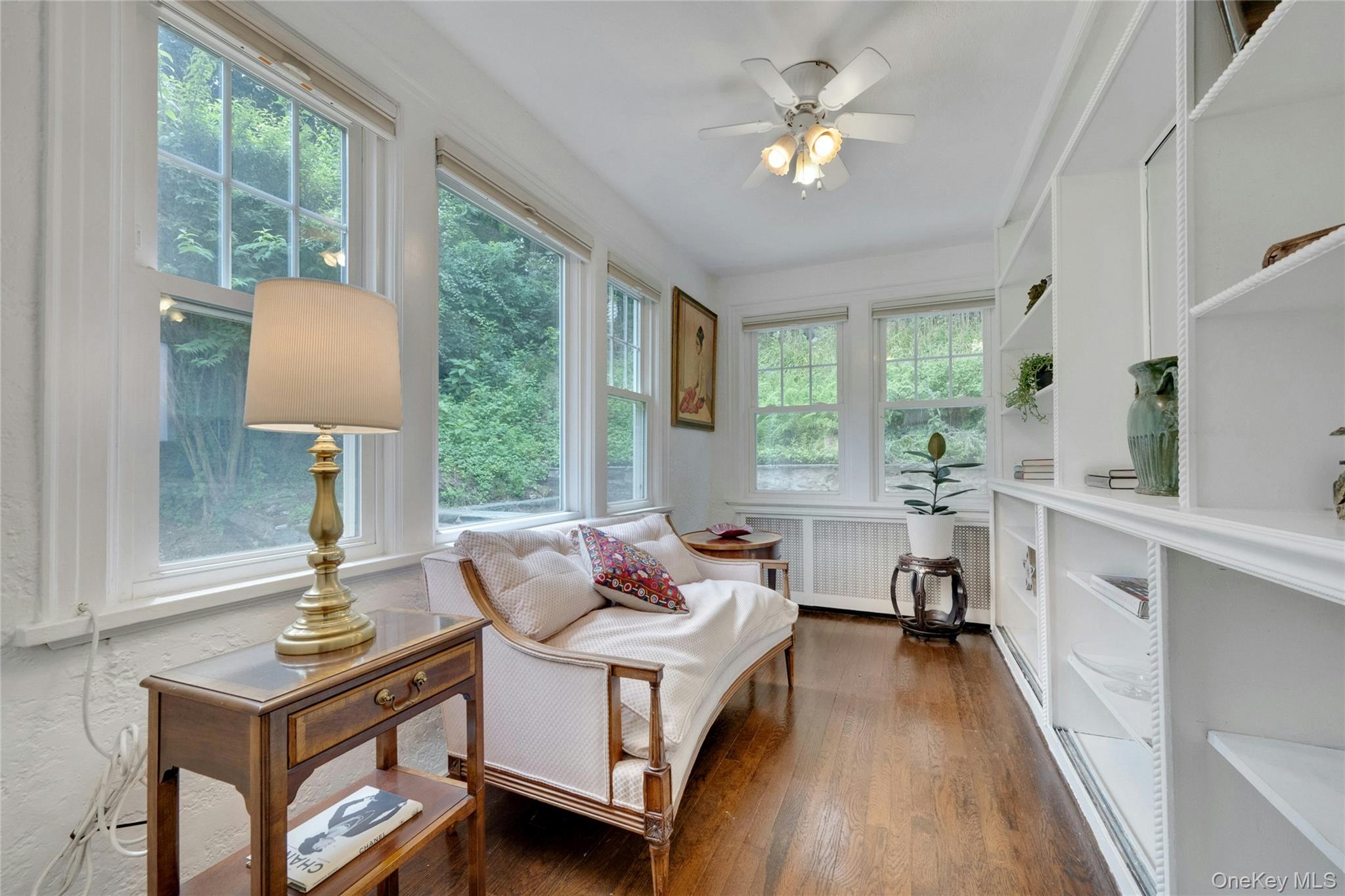 1179 Post Road Scarsdale, NY 10583 - Photo 10 of 24 Built in book case with view of the side and backyard. Sunfilled space.