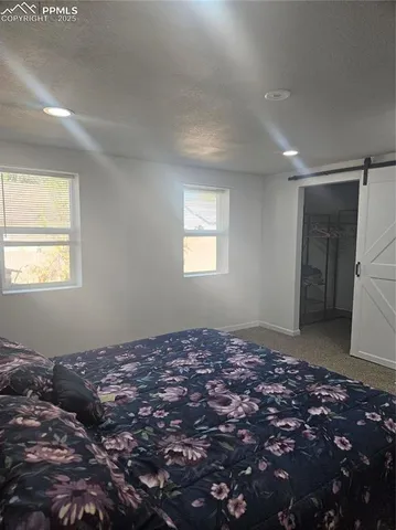 a view of a big room with window and wooden floor