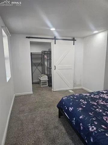 a bedroom with a bed and a mirror