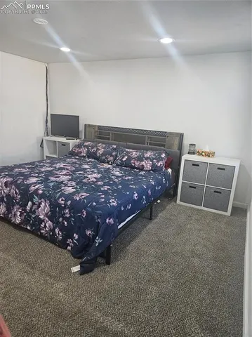 a bedroom with a bed and a couch