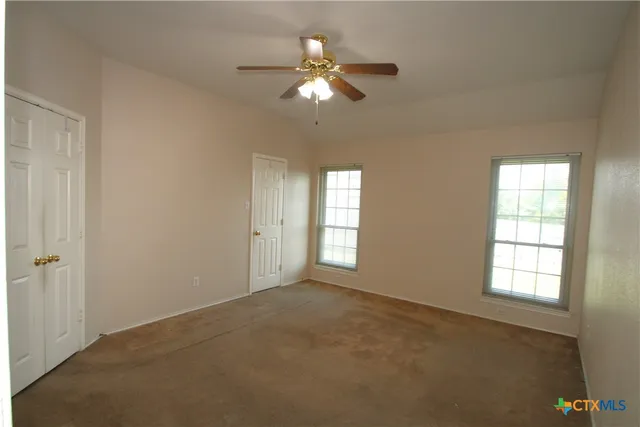 a view of an empty room with a window