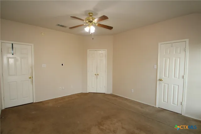 a view of a livingroom with a chandelier fan