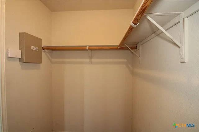 a view of walk in closet with empty racks