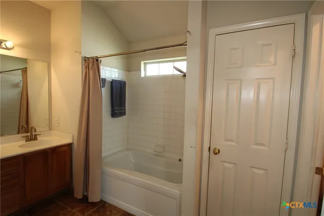 a bathroom with a bathtub and a sink