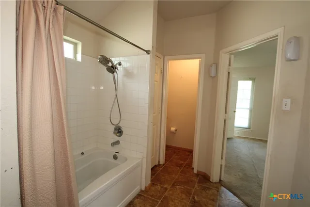 a bathroom with a glass shower door