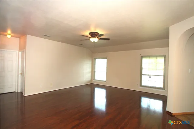 wooden floor in an empty room with a window