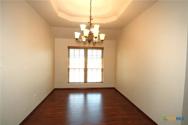 a view of a room with wooden floor and windows
