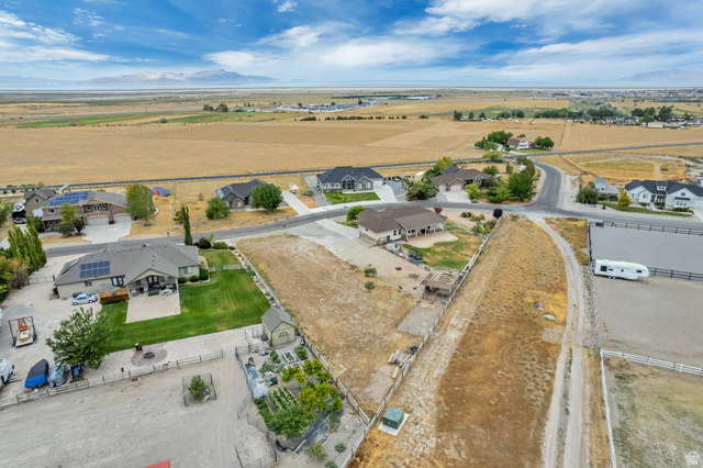 7296 Ridge Road Lake Point, UT 84074 - Photo 53 of 54 Expansive property featuring a large parcel of undeveloped land, several residential structures, a private dirt access road, and an equestrian arena
