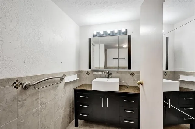 a bathroom with a double vanity sink and a mirror