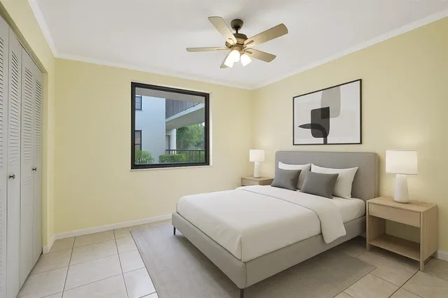 a bedroom with a bed and a painting on the wall