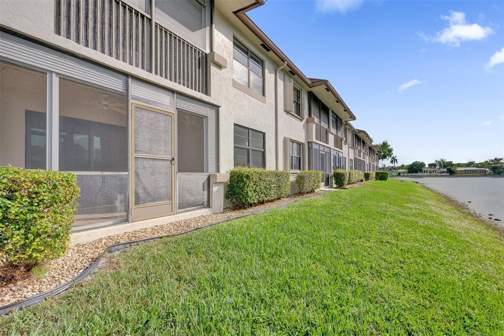 9573 West McNab Road, Unit 109 Tamarac, FL 33321 - Photo 2 of 29 a house view with a garden space