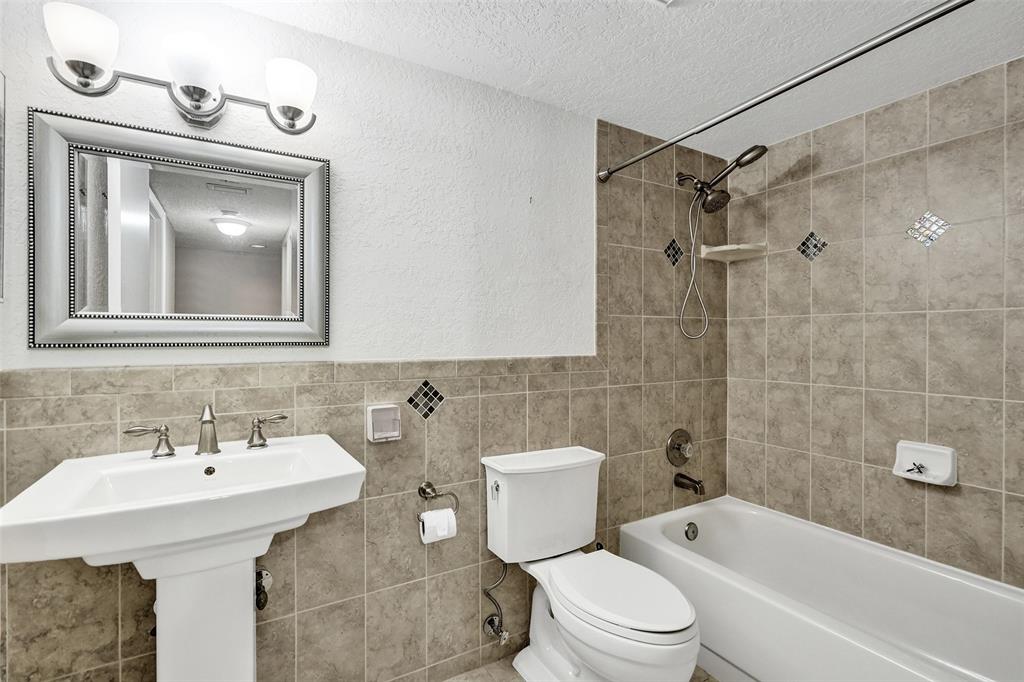 9573 West McNab Road, Unit 109 Tamarac, FL 33321 - Photo 22 of 29 a bathroom with a sink toilet and shower