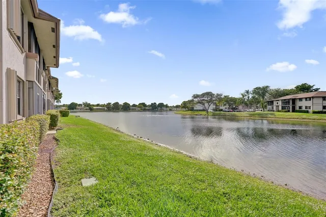 a view of a lake with houses in the background