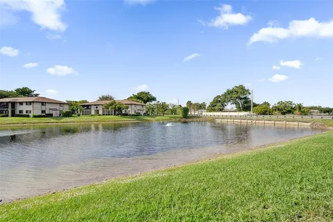 a view of a lake with houses in the background