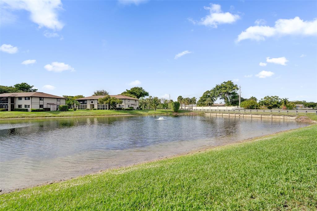 9573 West McNab Road, Unit 109 Tamarac, FL 33321 - Photo 3 of 29 a view of a lake with houses in the background