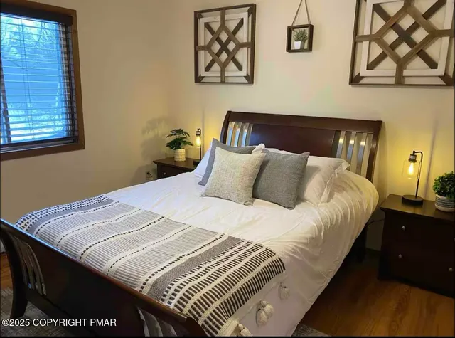 a bedroom with a bed and wall painting