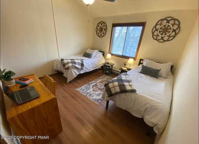 a bedroom with furniture and a wooden floor