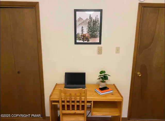 a bedroom with a bed and a painting on the wall